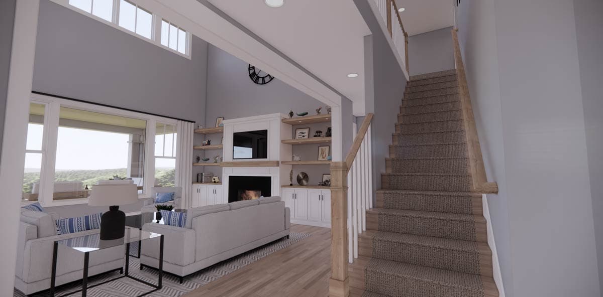 A modern living room with a fireplace, built-in shelving, and a staircase leading upstairs. Large windows reveal an outdoor view.