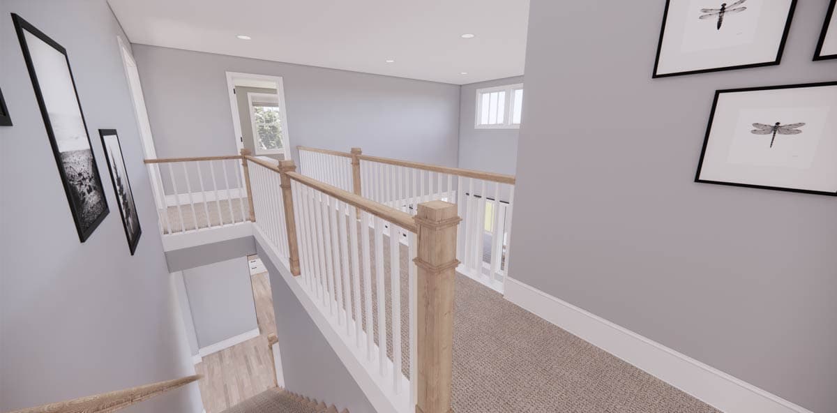 A hallway with a staircase, featuring white railings and framed artwork on the wall. The space has a modern, airy design.