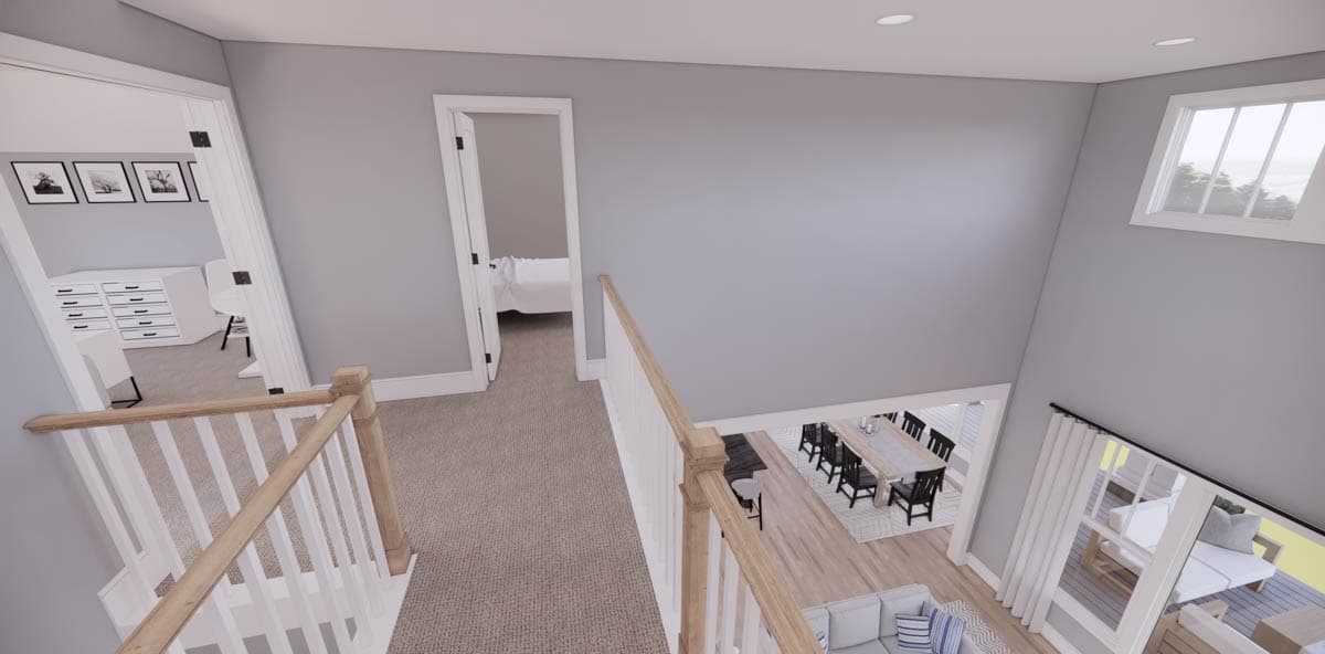 A two-story interior view from above the staircase, showcasing the dining area, a bedroom entrance, and an office. Natural light streams in.