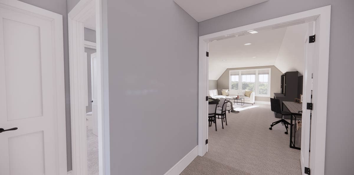 View through a doorway into a modern room with a couch, table, and workspace. Another doorway and a closed white door are visible.