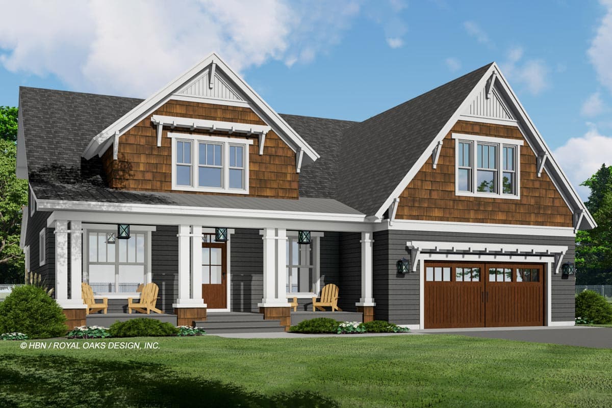 A craftsman-style house featuring a dark grey exterior, brown shake siding, a large front porch with Adirondack chairs, and a two-car garage.
