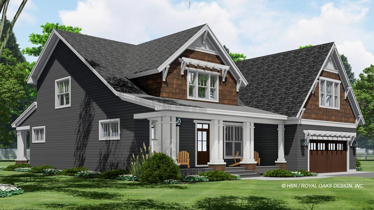 A craftsman-style house with dark gray siding, a welcoming porch, and a brown garage door. Lush green grass and landscaping surround the home.
