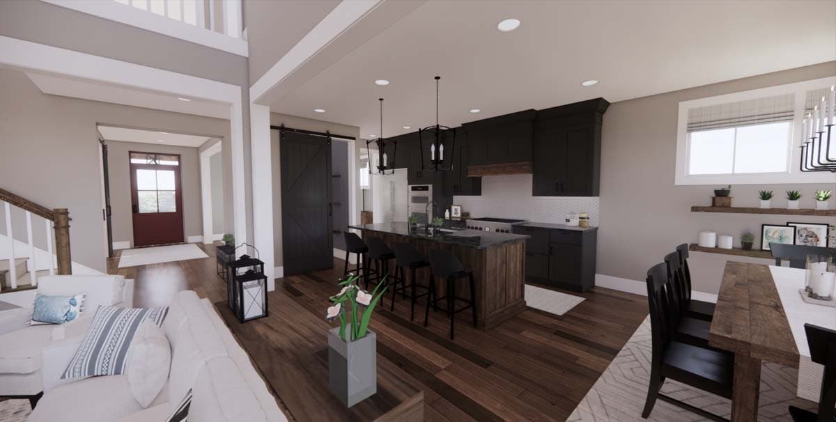 Spacious, modern kitchen with dark cabinets, a large island with bar stools, and a dining area. A living room and entry are visible.