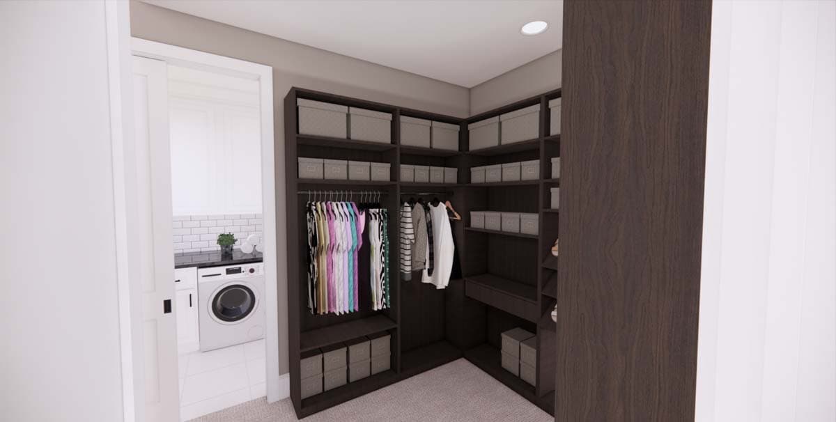 A modern walk-in closet with dark wooden shelving, housing clothes and storage bins. The entrance to a laundry area is partially visible.