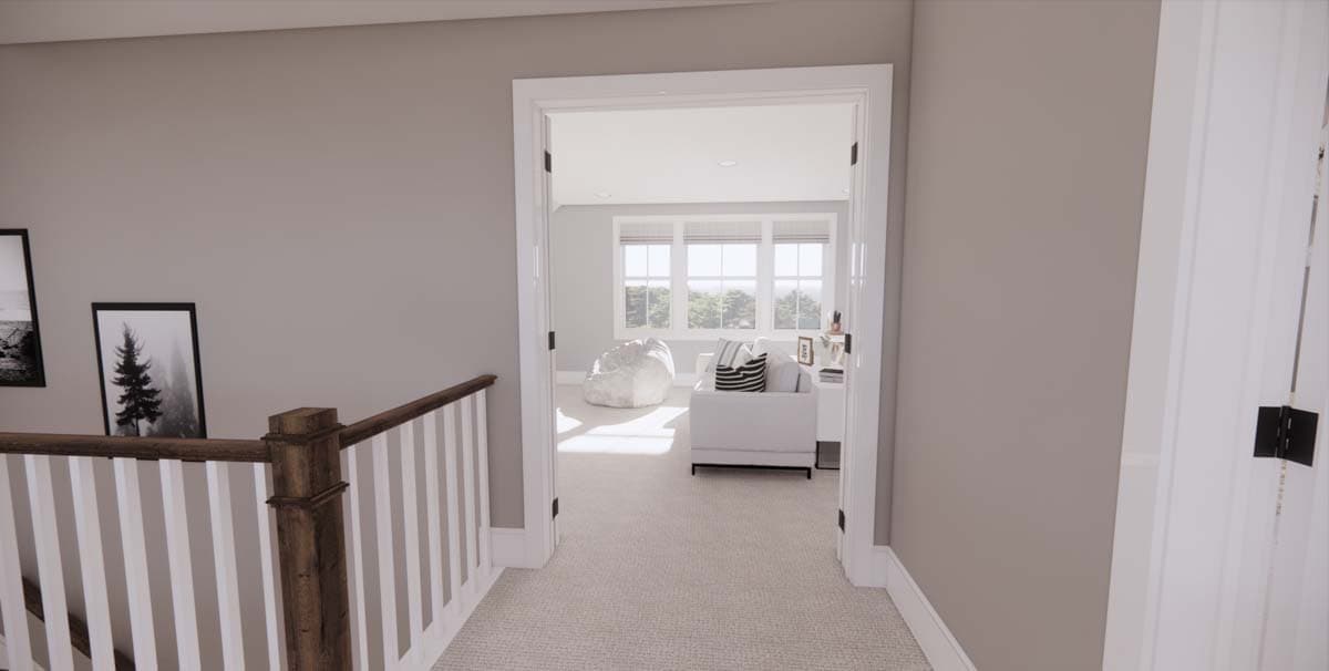 View from a hallway into a bright living area, framed by a doorway and lit by sunlight. A staircase with a wooden handrail is in the foreground.