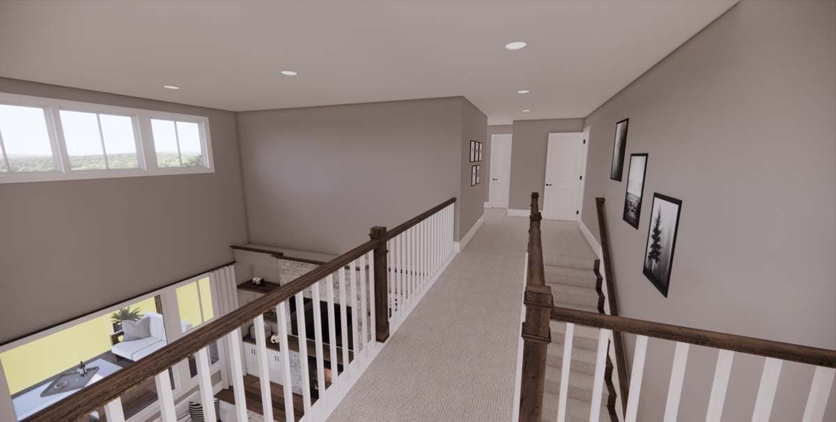 Interior view of a modern home with a second-floor hallway overlooking a lower level. Features include a staircase, wall art, and a large window.