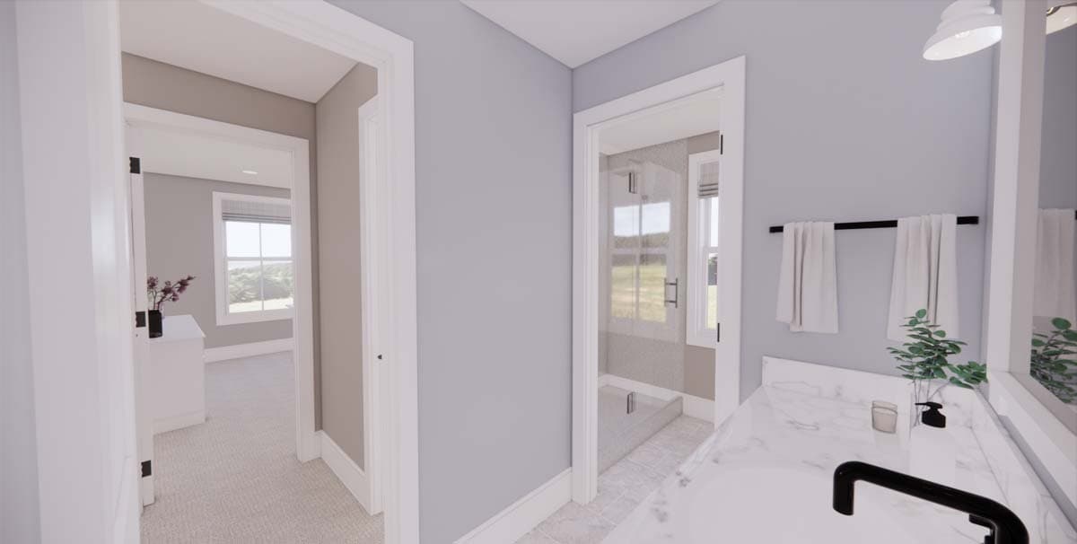 A modern bathroom showcases a marble countertop and a glass shower. The view extends into another room with a window, creating an open ambiance.