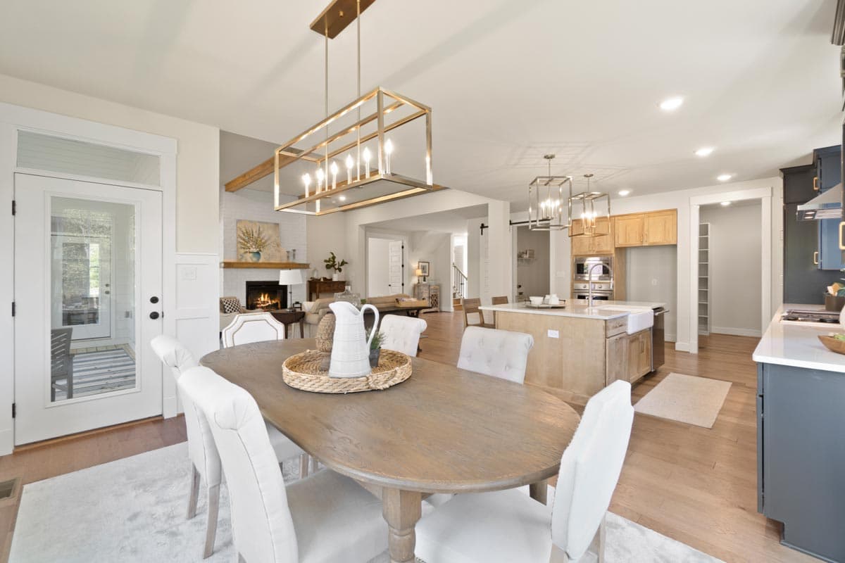 Open-concept interior with dining area, kitchen island, fireplace, and living space.