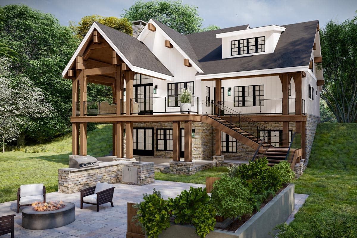 House plan exterior with a two-story structure, timber framing, gables, dormers, stone accents, and an outdoor kitchen.