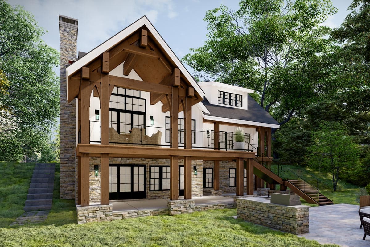 House plan exterior: Timber frame accents, stone chimney, multiple porches, and large windows on a multi-story home.