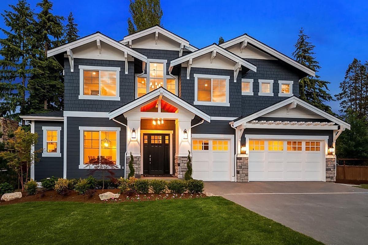 Craftsman house plan exterior with two stories. Features include multiple gables, a front entry porch, and a side-entry garage with stone accents.