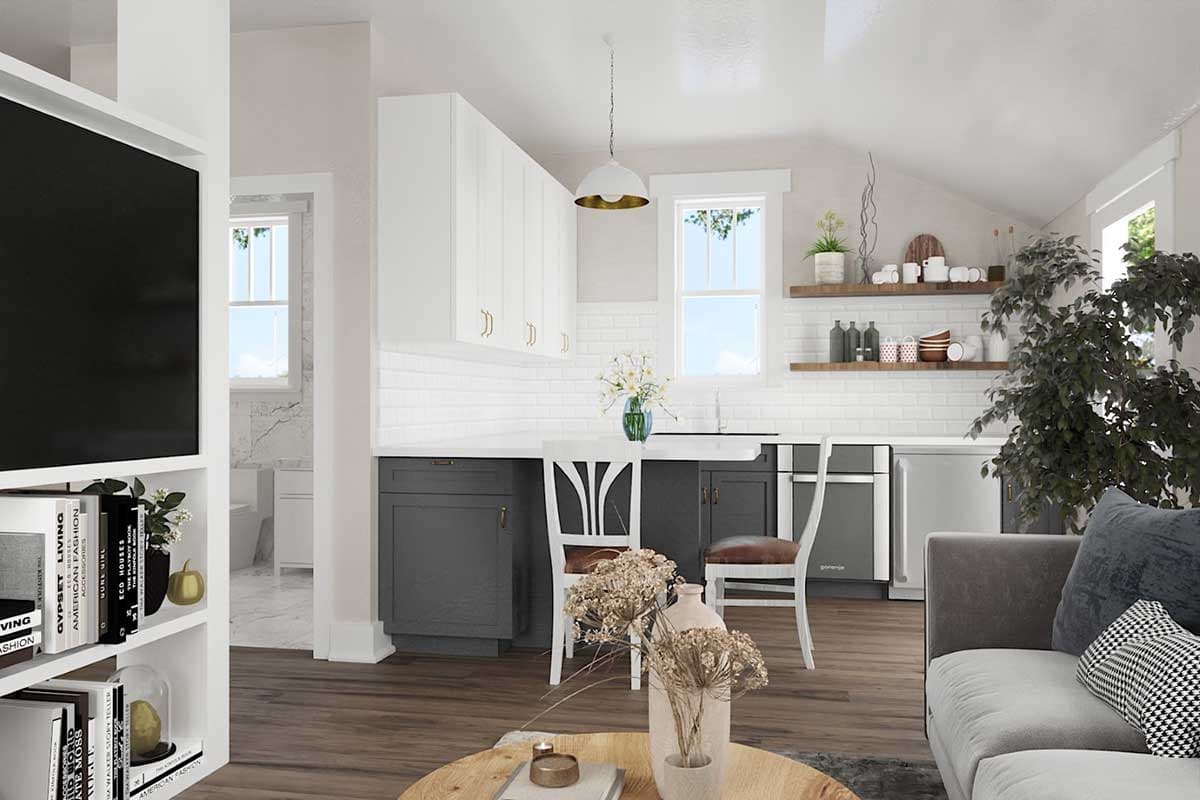 Modern kitchen with white subway tile backsplash, dark lower cabinets, white upper cabinets, and a breakfast bar.