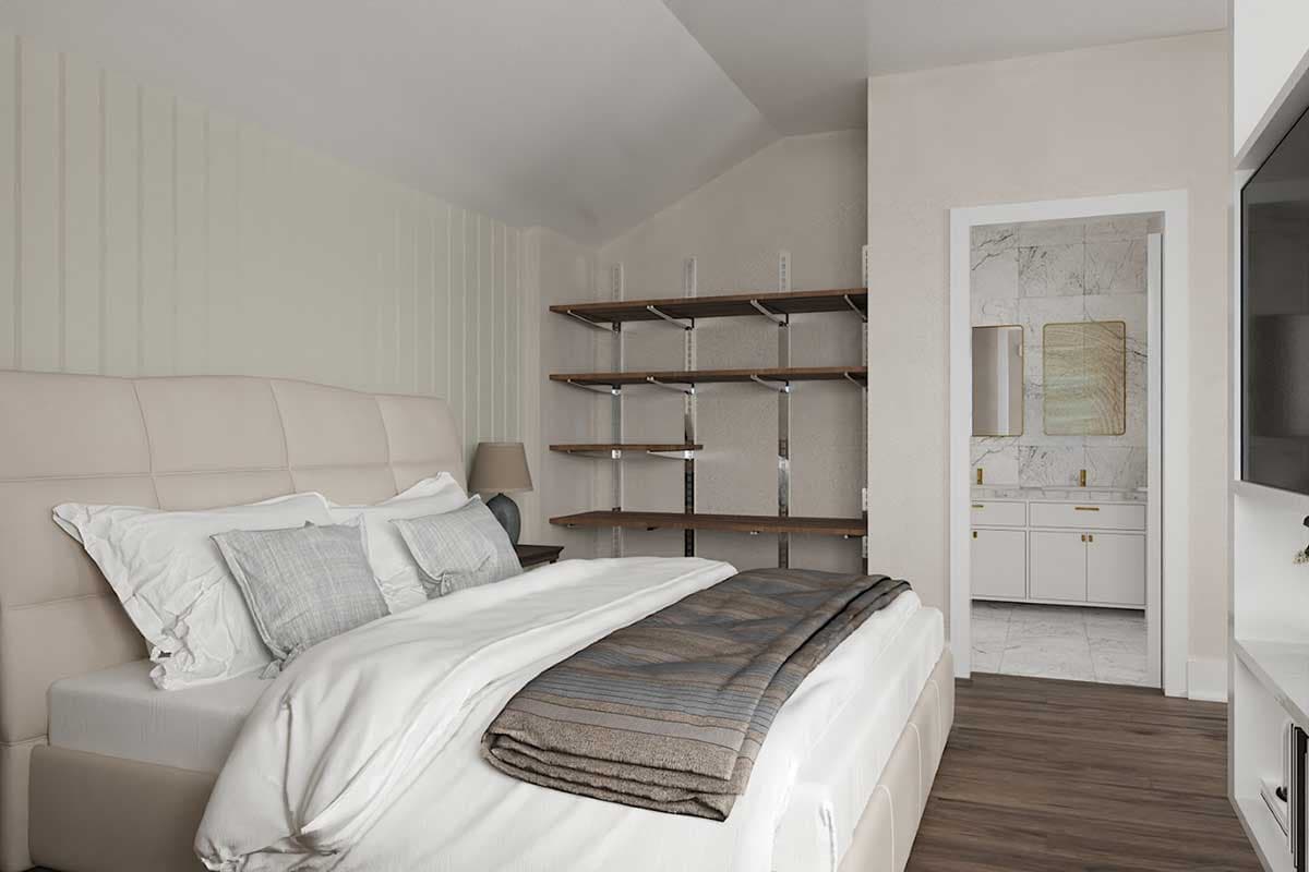Bedroom with a bed, open shelving system, and view into an ensuite bathroom with double vanity.