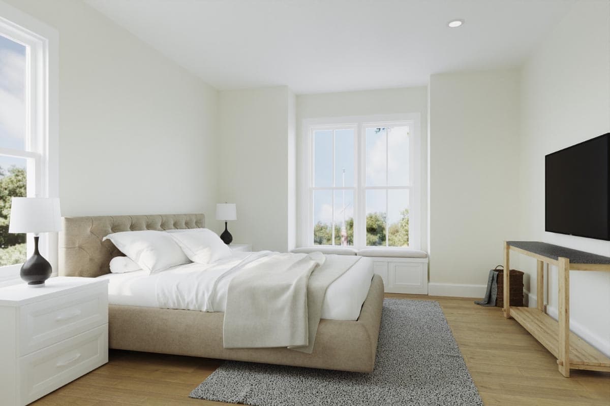 Bedroom interior with bed, bedside tables, large window, built-in bench, and television.
