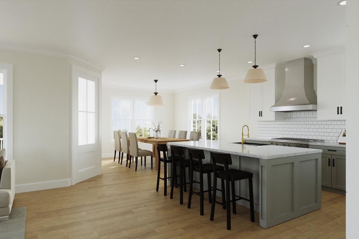 Open concept kitchen and dining area with large island, stainless steel range hood, and wood dining table.