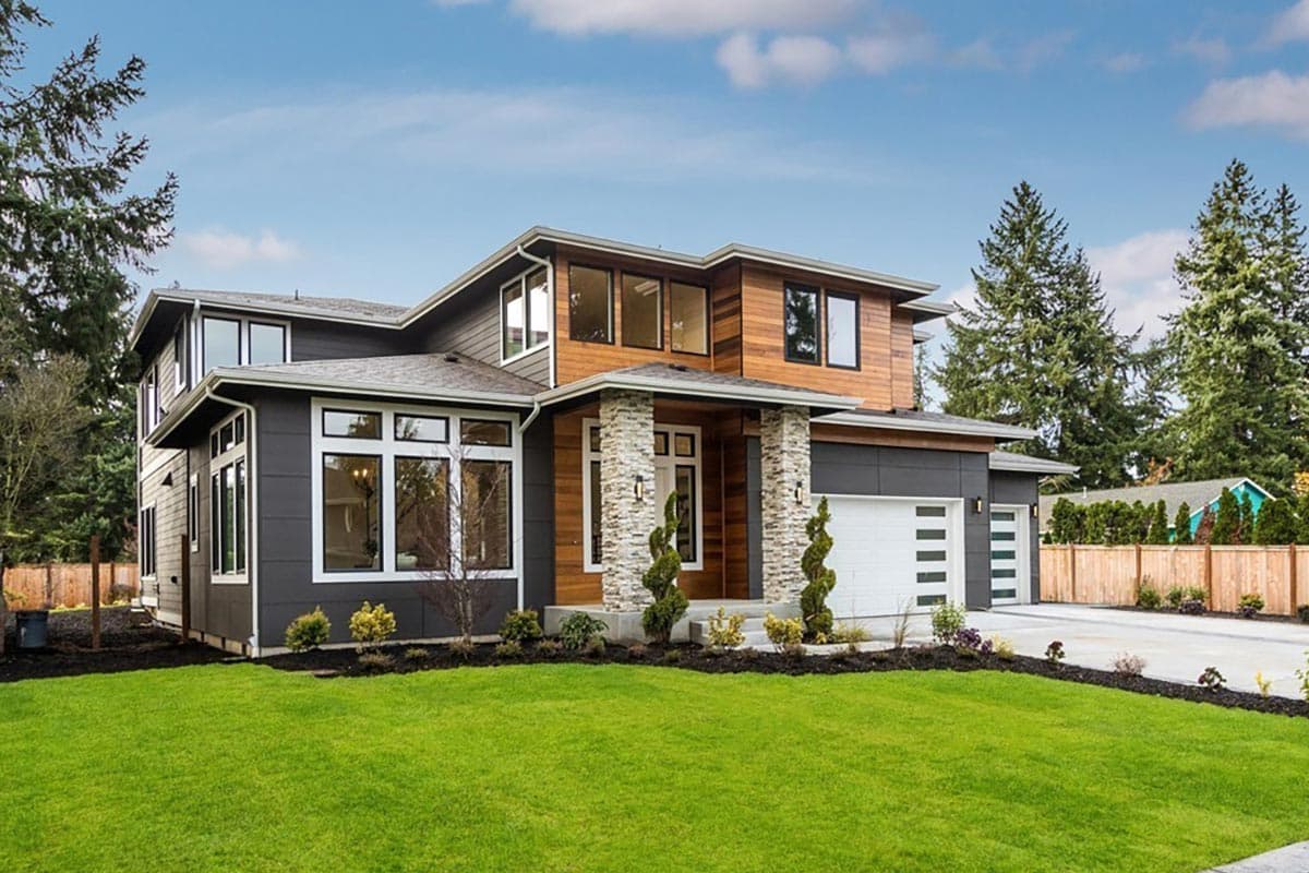 Modern two-story house plan exterior with stacked stone columns, wood siding, large windows, and a three-car garage.