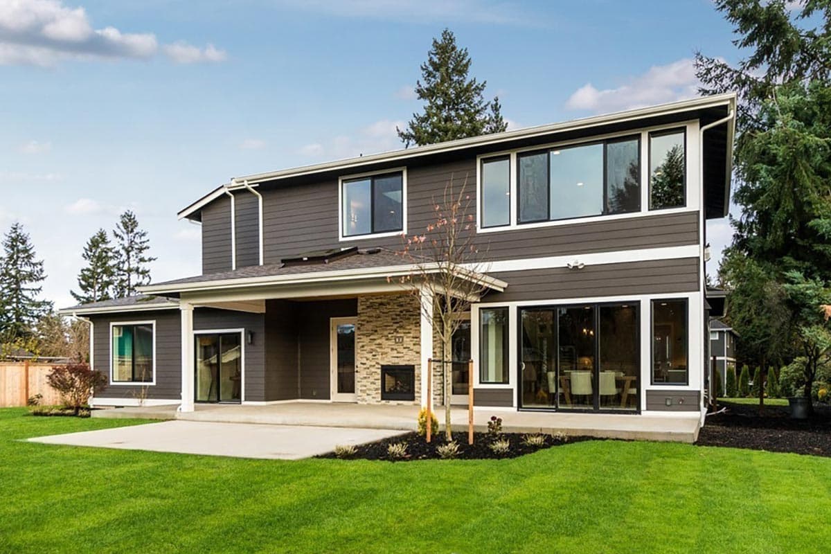 House plan exterior: Modern style, two stories, covered patio with stone fireplace, large windows, and horizontal siding.