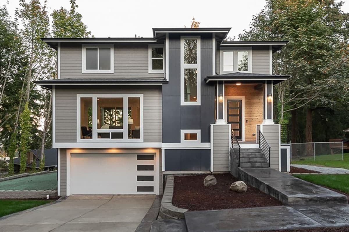 House plan exterior. Two-story modern style with garage, entry porch, and varied rooflines. Horizontal siding with contrasting vertical accents.