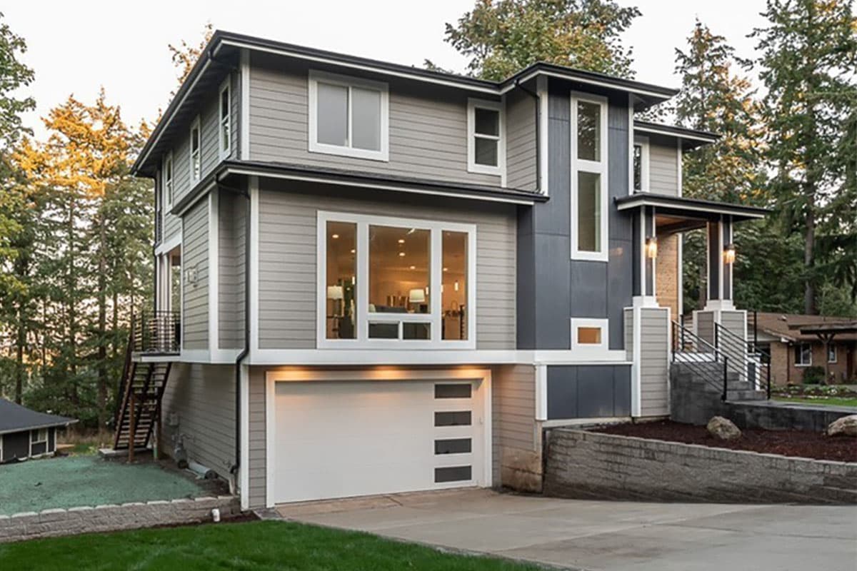 Modern two-story house plan exterior with large windows, a covered entry porch with columns, and a side-facing garage.