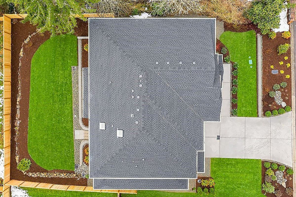 House plan exterior from above showing a multi-story house with a hipped roof, gables, and asphalt shingles.