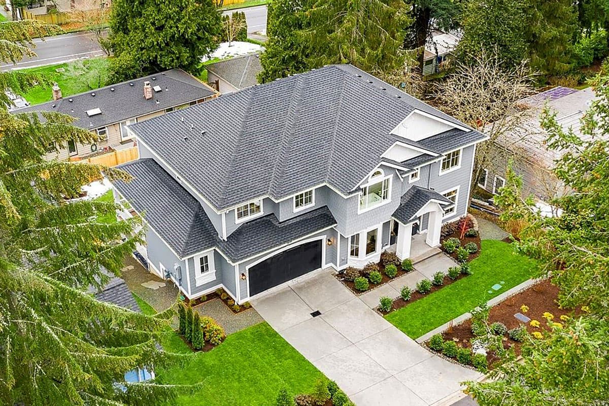 House plan exterior: two-story Modern Farmhouse with attached garage, prominent gables, and a covered front entry.