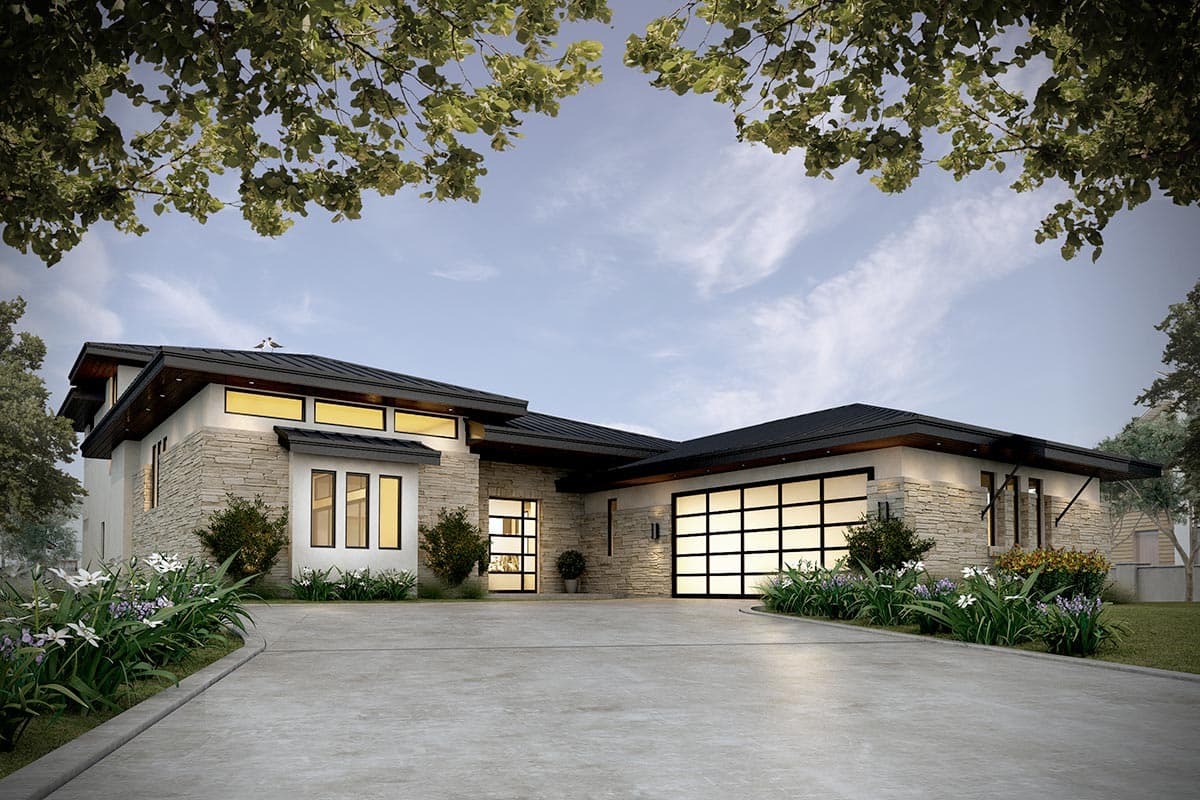 House plan exterior. Modern, one-story home with a flat roof, stone facade, and glass garage door. Mature landscaping surrounds the driveway.