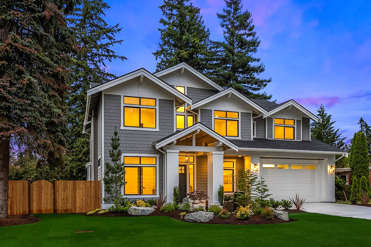 House plan exterior: two-story Modern Farmhouse with prominent gables, covered entry, and attached garage.