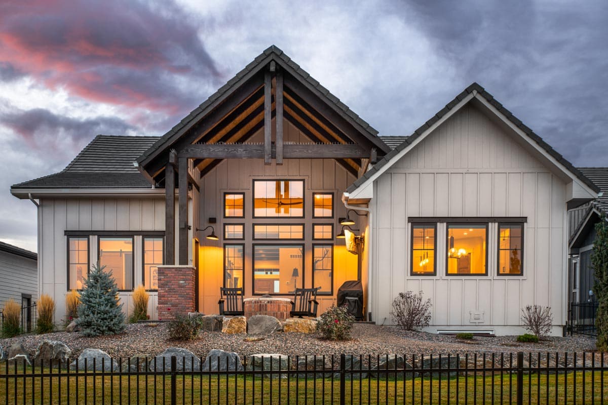 Modern Farmhouse exterior with large gabled roof, exposed beams, and extensive window wall.