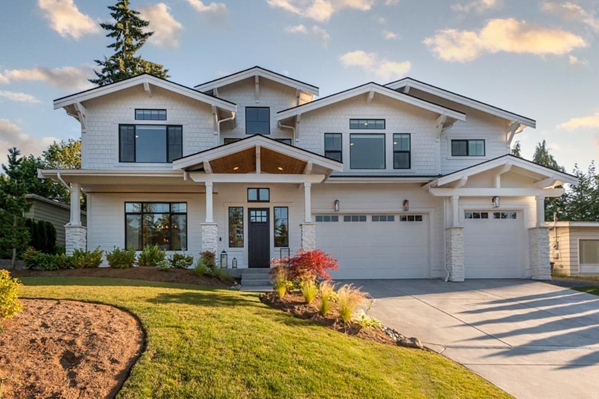 Two-story house plan exterior with gables, a covered entry with exposed beams, and a triple-bay garage.