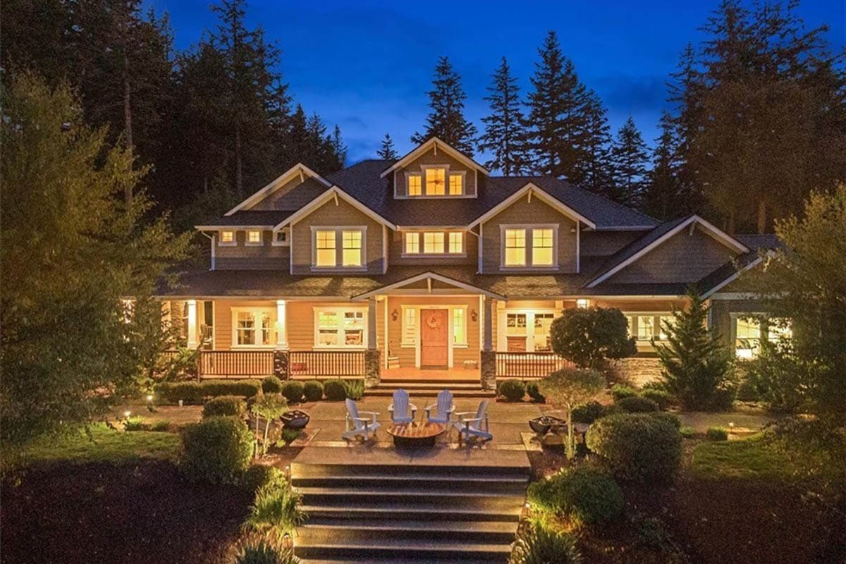 House plan exterior. Two-story Craftsman home with gabled roof, multiple dormers, and a large front porch.