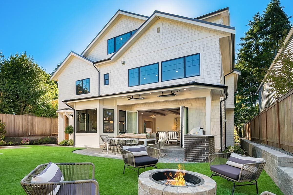 Modern Farmhouse house plan exterior, multiple gables, large windows, covered patio with bi-fold doors, and outdoor kitchen.