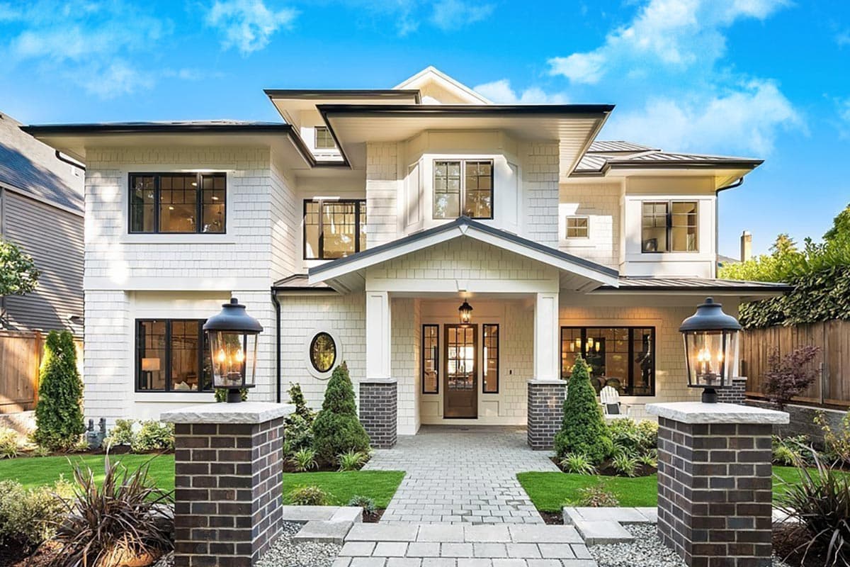 House plan exterior featuring a two-story design with gabled rooflines, a covered porch, and a combination of shingle and clapboard siding.