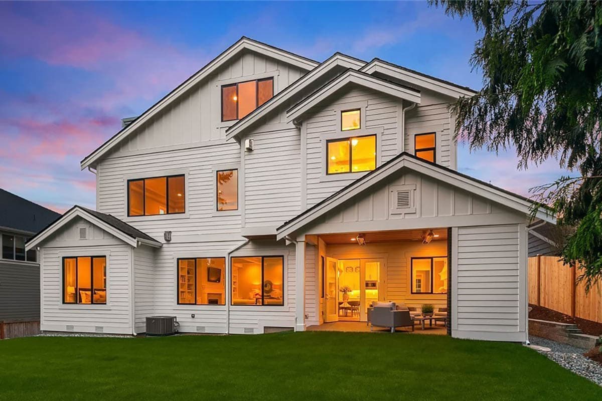Modern Farmhouse house plan exterior with gables, multiple stories, horizontal siding, and covered patio.