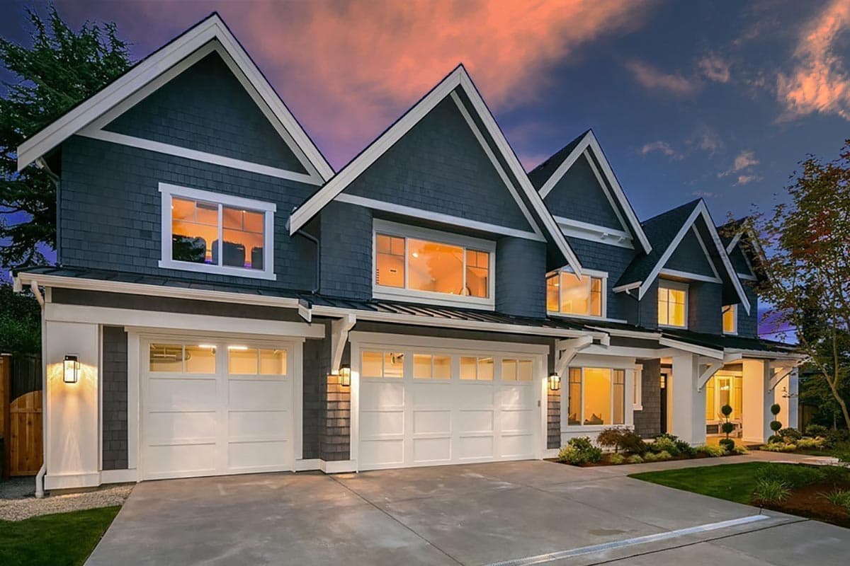 House plan exterior. Two-story home with Craftsman style. Features include multiple gables, white trim, and a three-car garage.