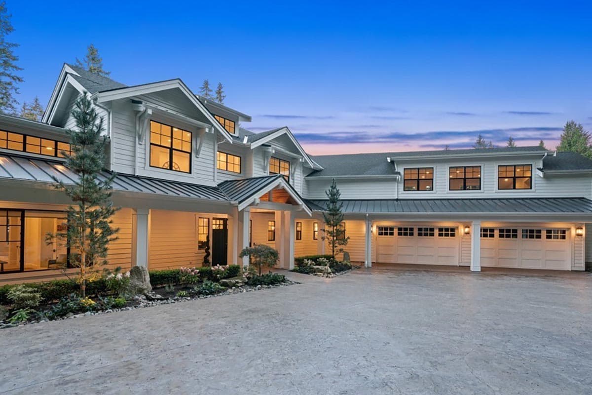 Modern Farmhouse house plan exterior with multiple gables, a covered porch, and an attached four-car garage.