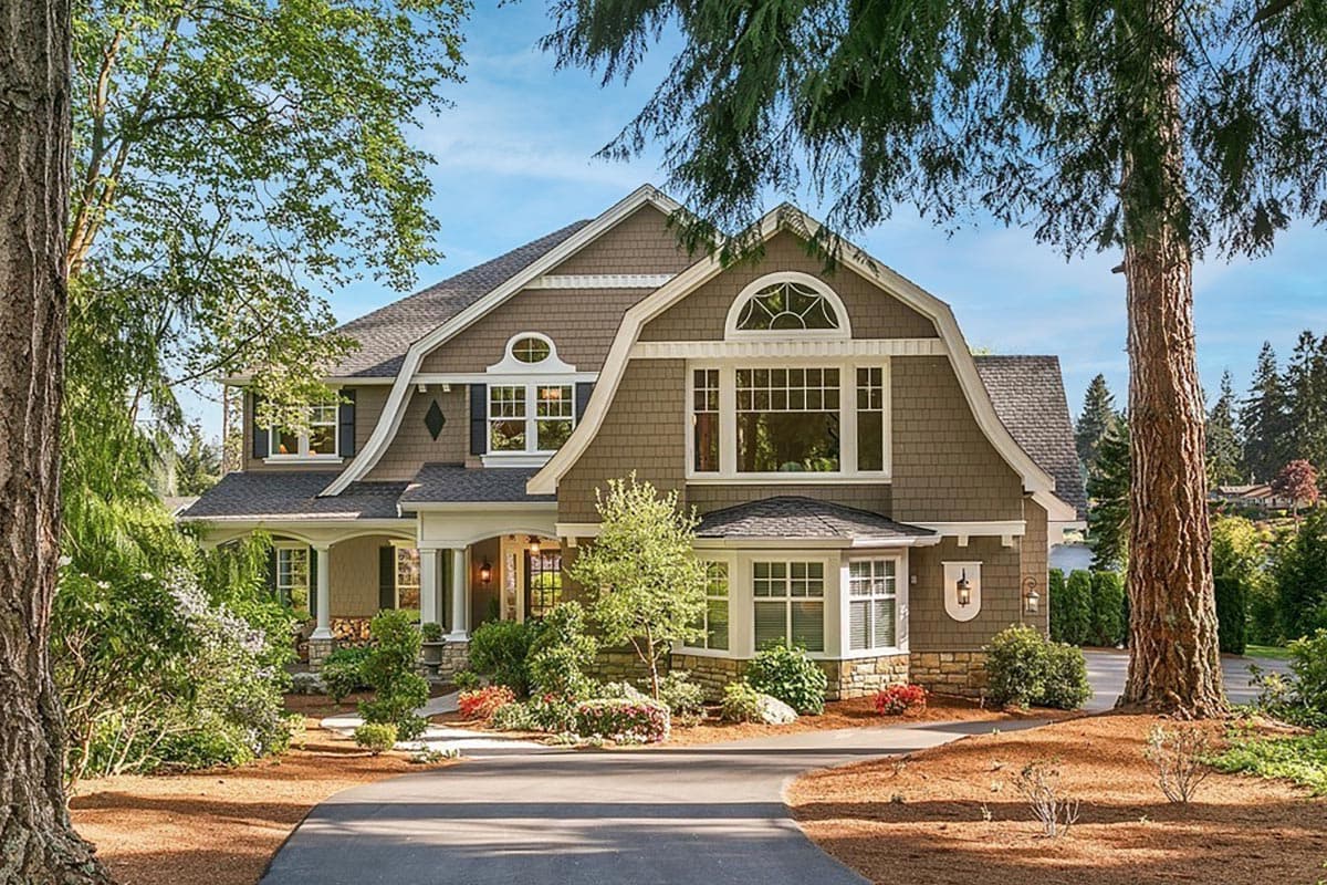 House plan exterior with Craftsman-style elements. Features include a two-story design, dormers, a covered porch, and a complex roofline. 
