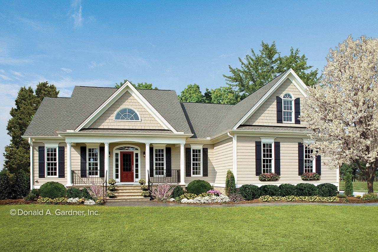 House plan exterior. Ranch style with a front porch supported by columns. Features include gables, dormers, and multiple windows with black shutters.