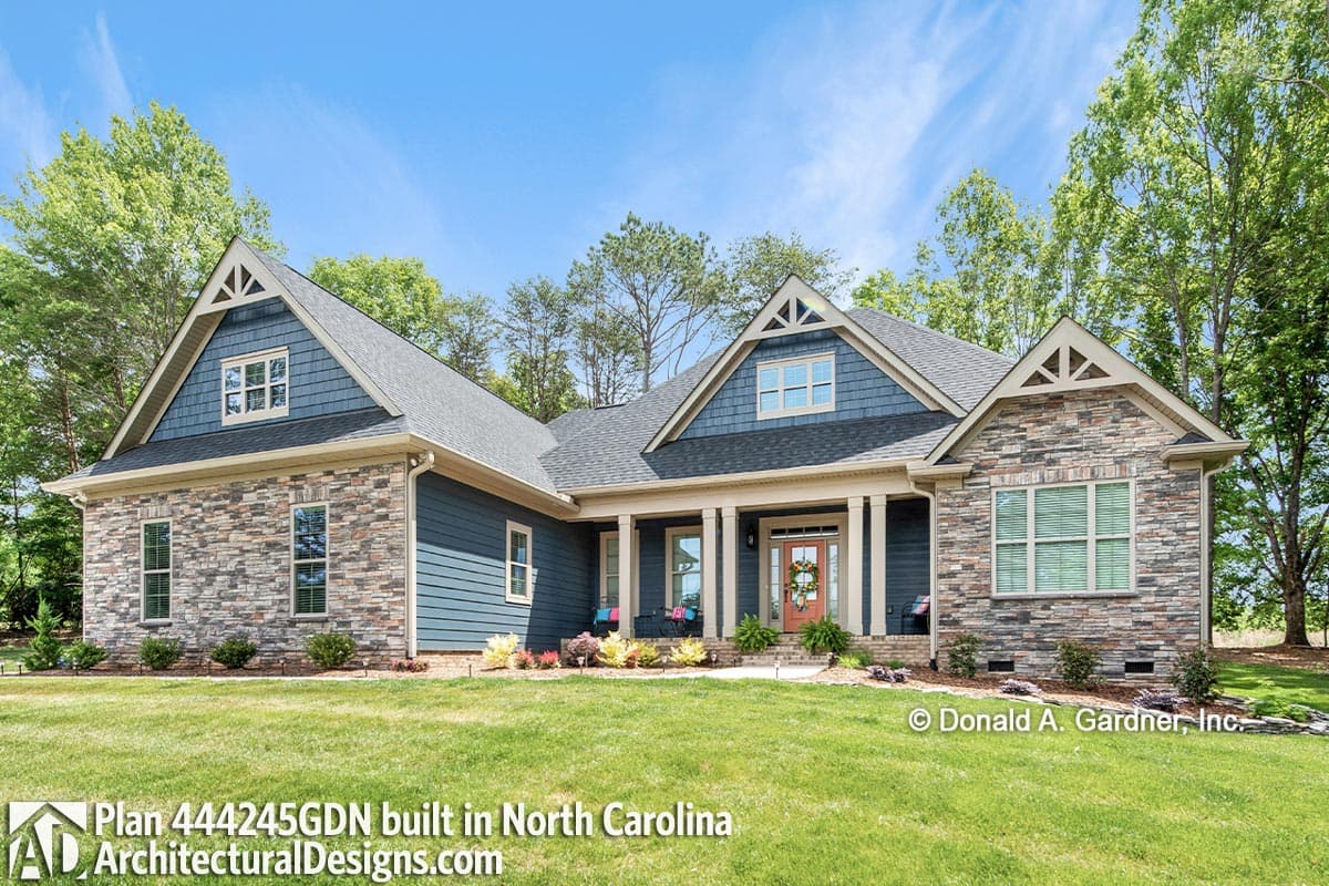 House plan exterior: Ranch style with stone and siding, covered front porch with columns, and prominent gables.