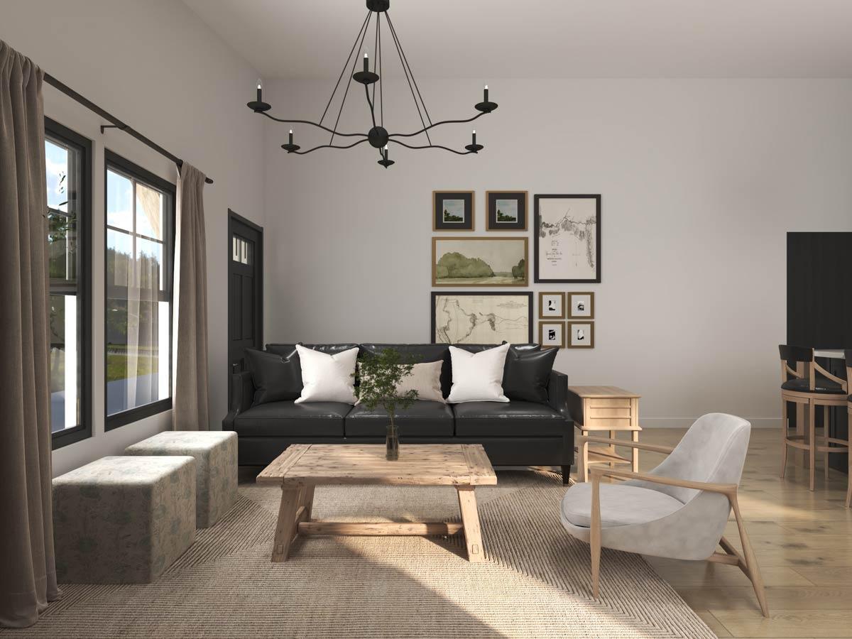 Living room with black leather sofa, wood coffee table, armchair, and two upholstered ottomans.