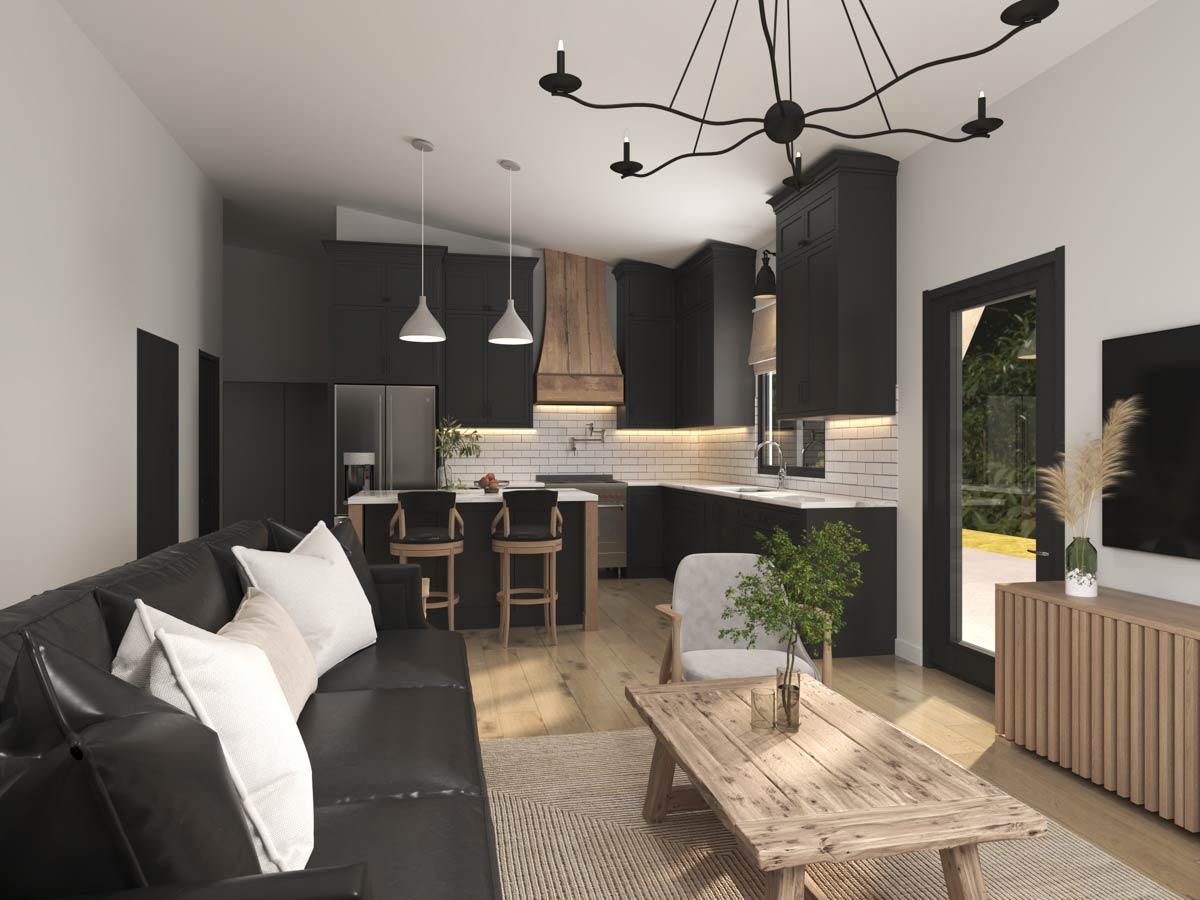 Open concept living area with black sofa and kitchen featuring dark cabinets, subway tile backsplash, and island with bar stools.