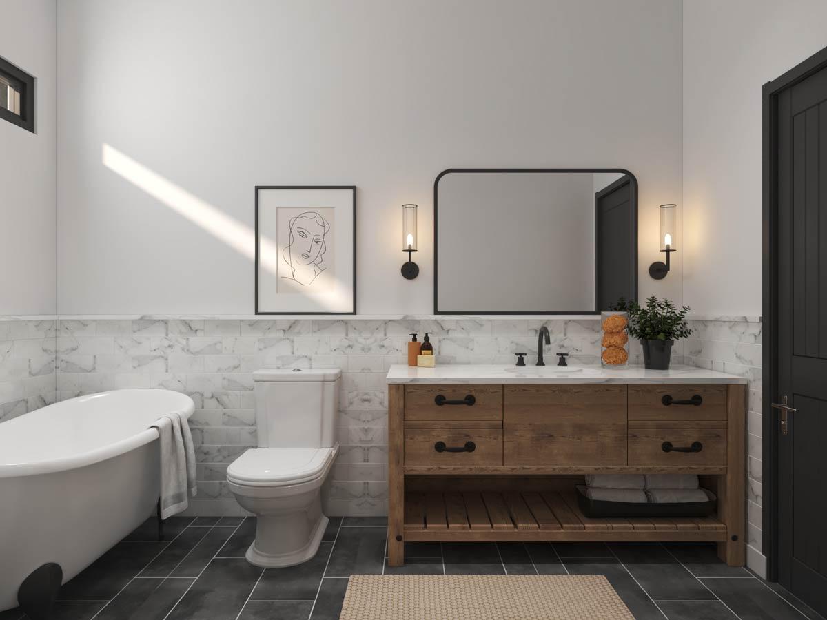 Bathroom with clawfoot tub, toilet, marble tile wainscoting, wooden vanity with double sinks, and black door.