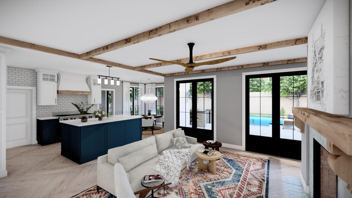 Open concept living area with kitchen island, living room with fireplace, and French doors leading to pool.