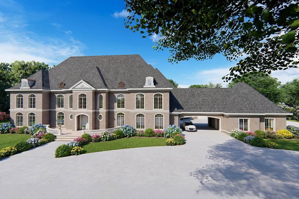 House plan exterior: Grand brick residence with mansard roof, arched windows, central entry, and attached porte-cochère.