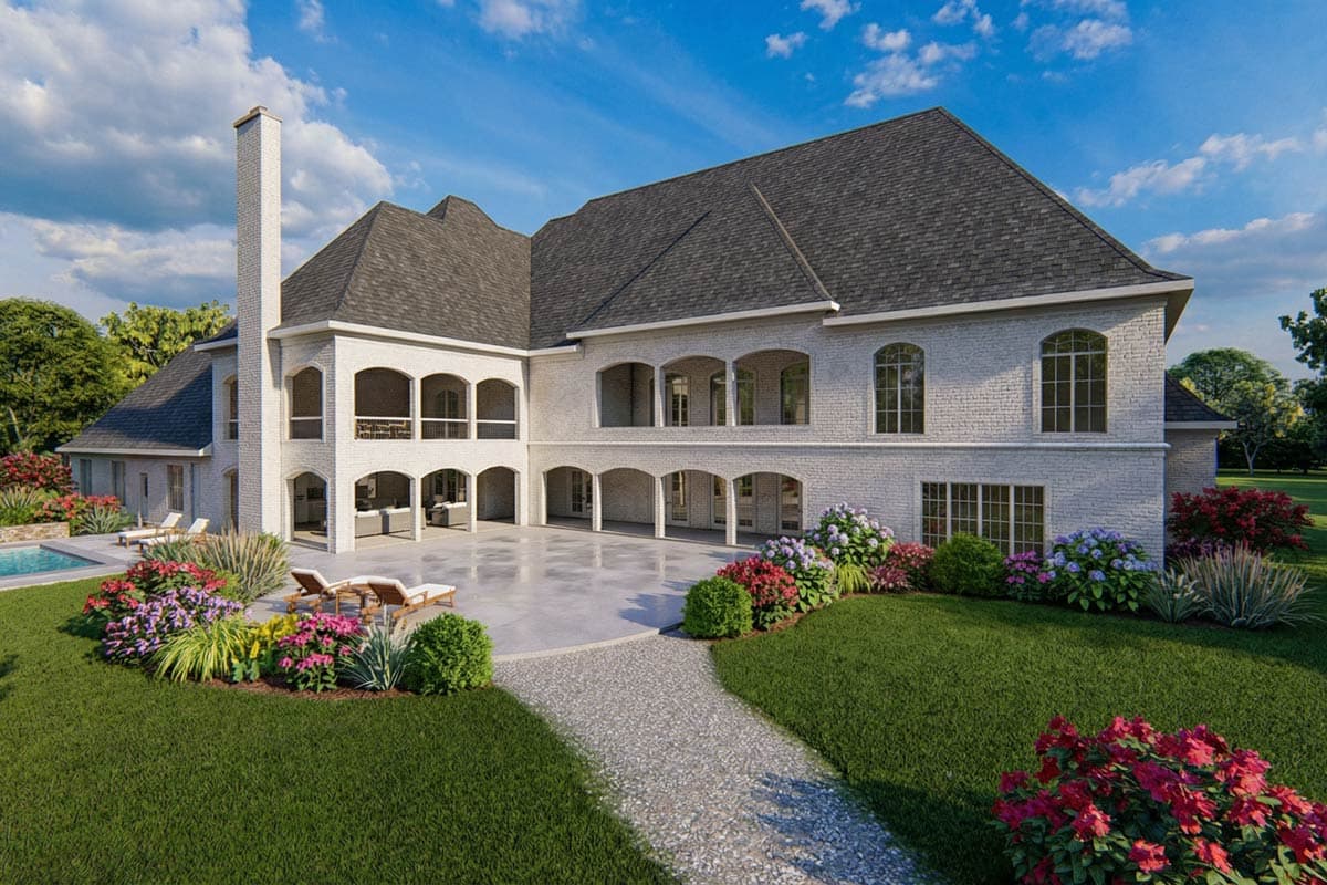 House plan exterior with white brick, arched covered patios, multiple gables, and a prominent chimney.