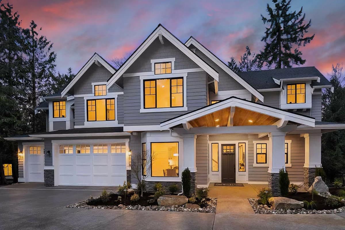 House plan exterior with Craftsman style, two stories, front-facing gables, covered porch, and attached garage with multiple windows.