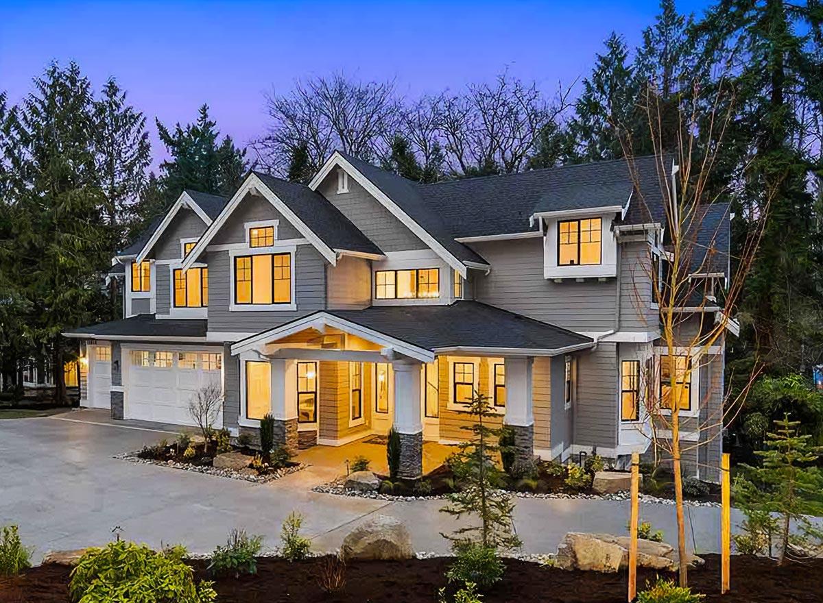 House plan exterior: Modern Craftsman style, two stories, prominent gabled dormers, covered entry porch, and attached three-car garage.