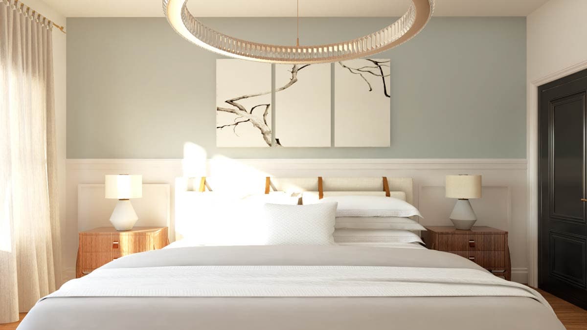 Bedroom interior with a large bed, bedside tables, modern pendant light, and artwork of tree branches.