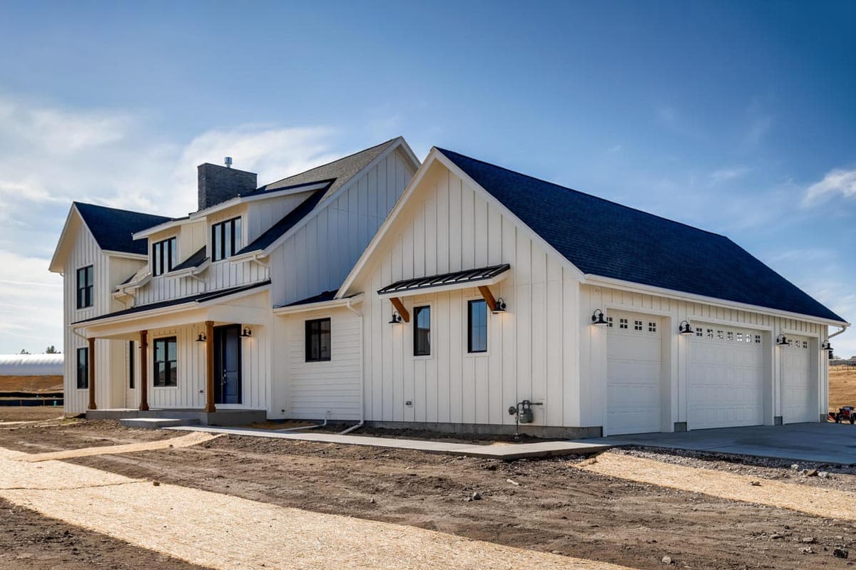 Modern Farmhouse house plan exterior with gabled rooflines, board-and-batten siding, covered porch, and three-car garage.
