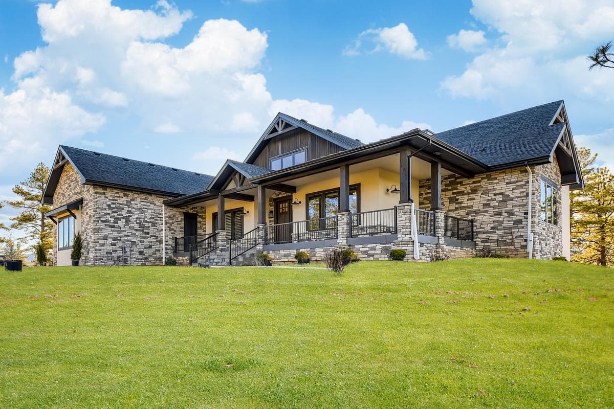 House plan exterior with stone veneer, gabled roof, and covered porch. Features include a Craftsman style with a single story.