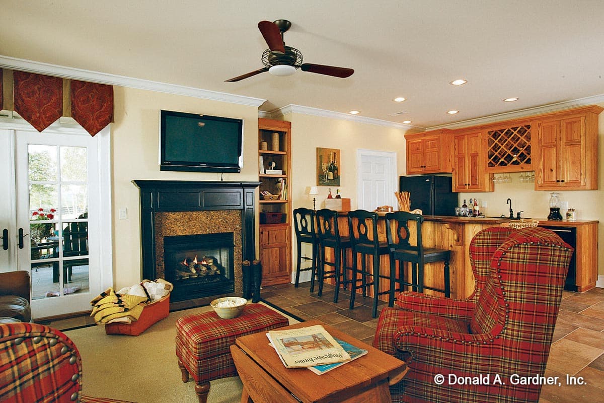 Open concept living area with fireplace, bar seating, and kitchen cabinetry with wine rack.